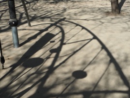 The shadow of a climbing frame makes an abstract pattern - Paris, April 2016