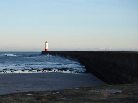 The pier starts as a sea wall running behind Berwick beach before turning a sharp corner...